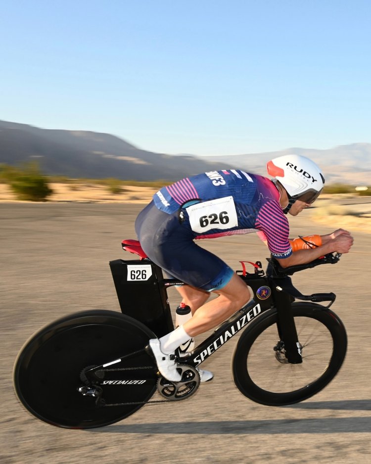 Coach Adam in a time trial position, cycling during a time trial race. 