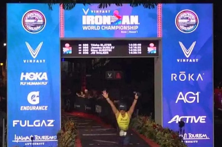 Photo of Trisha, one of Coach Adam's athletes, celebrating her finish at the Ironman World Championship.