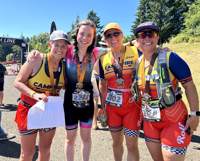 Happy athletes taking a photo together after a triathlon.