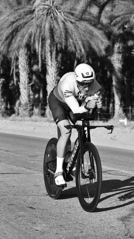 Coach Adam holding an aero position on his time trial bike during a race.