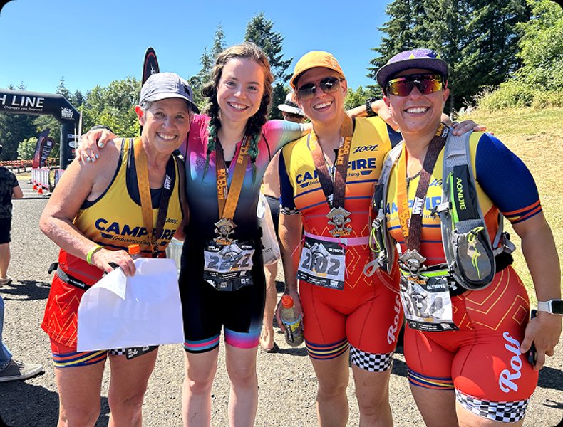 Group of happy athletes taking a picture together after a triathlon.